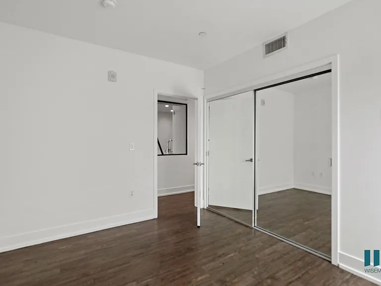 Bedroom with Mirrored Closet, Vinyl Flooring, and Recessed Lighting