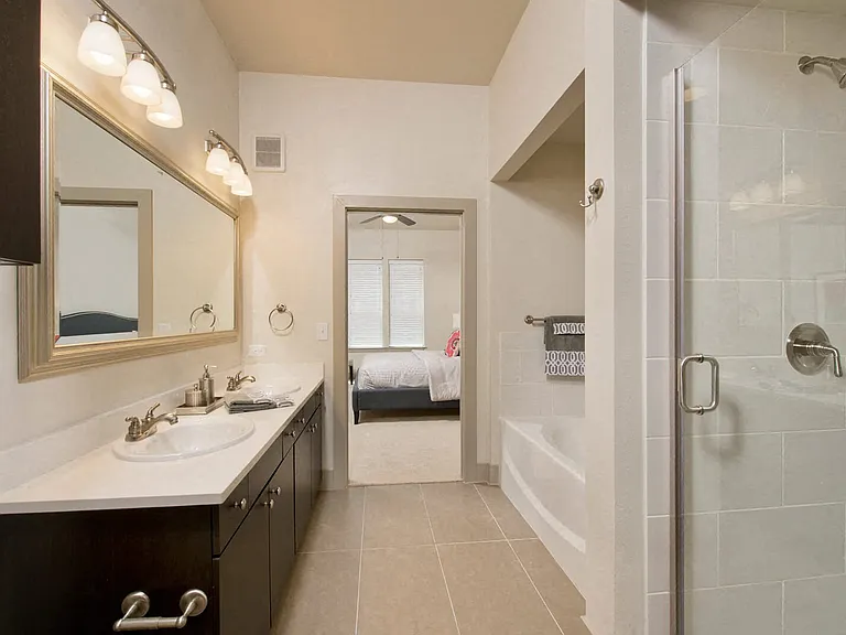 Select bathrooms feature both oversized soaking tubs and walk-in showers