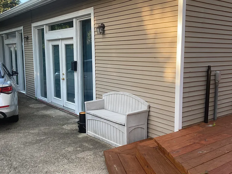 Front exterior of cottage with deck.