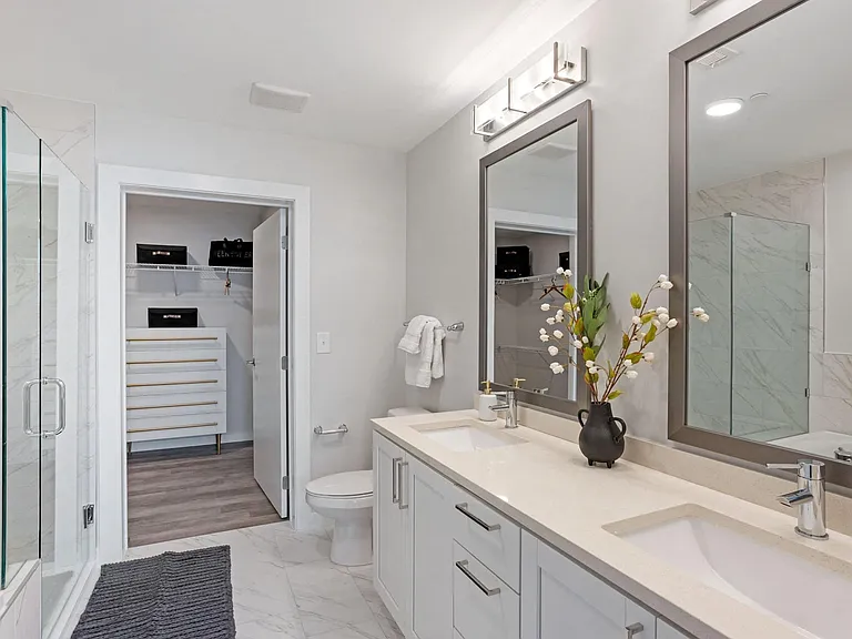 Polished Bathroom With Quartz Countertops and Pearl Paneled Cabinets