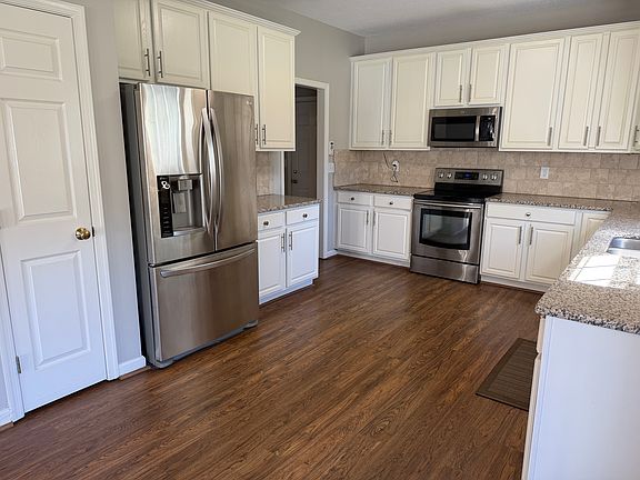The updated kitchen features granite counter tops, stainless steel appliances, pantry, and an abundance of upper and lower cabinet space with the lower cabinets featuring pull out shelving.