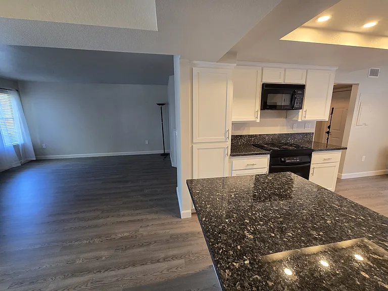 Open-concept kitchen flows seamlessly into the dining and living areas, creating an ideal space for entertaining.