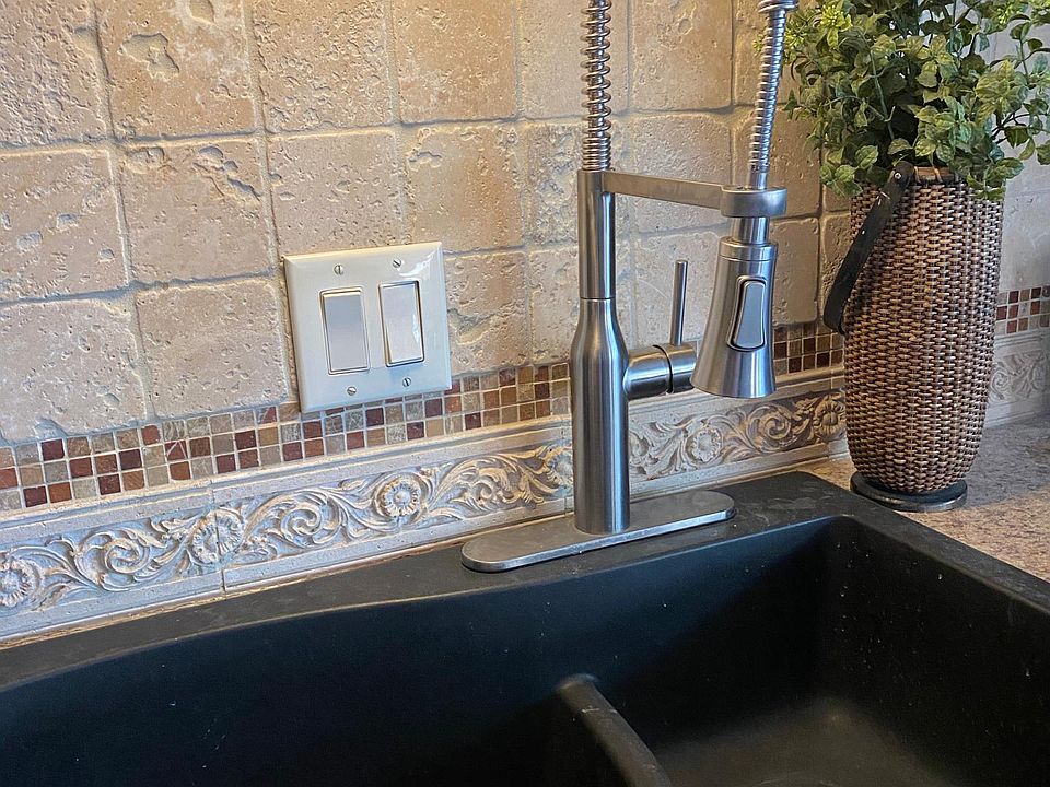 new faucet, tiled backsplash, granite sink