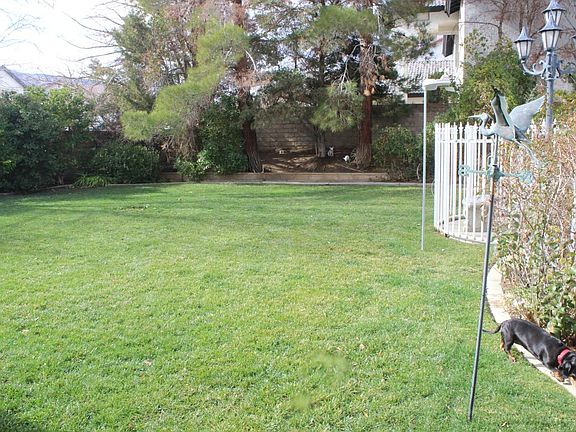 large backyard with a fenced pool
