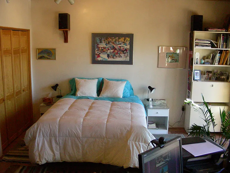 Second bedroom with separate entrance, deck, and hot tub outside. Office space in foreground.
