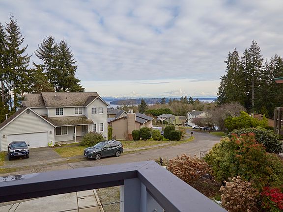 From the primary bedroom and from the deck outside it you can see Blake Island from end to end as well as West Seattle!