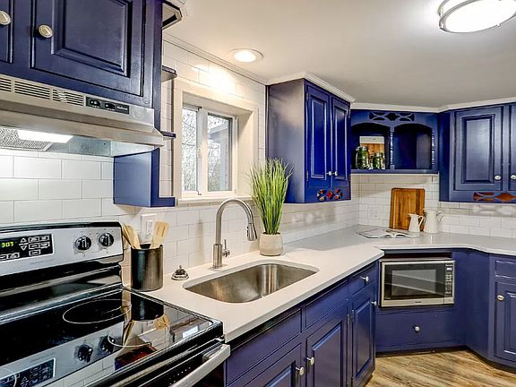Updated kitchen with quartz counters and stainless steel appliances