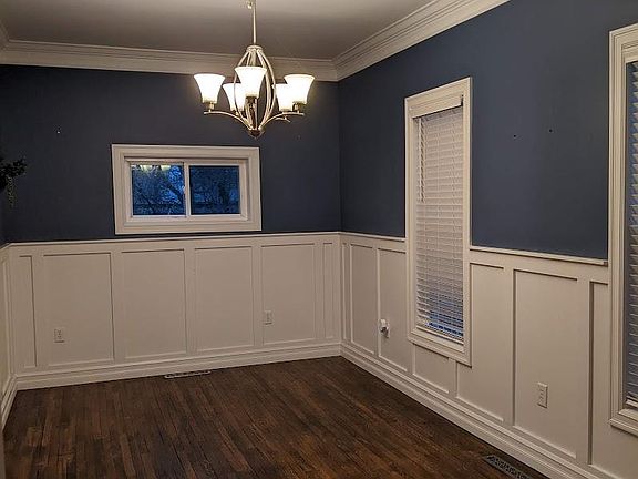 Large dining room with hardwood floors, ceiling fixture, crown moulding. First floor off from kitchen. Three windows. Mini blinds. Room size: 9.5' x 16.5'