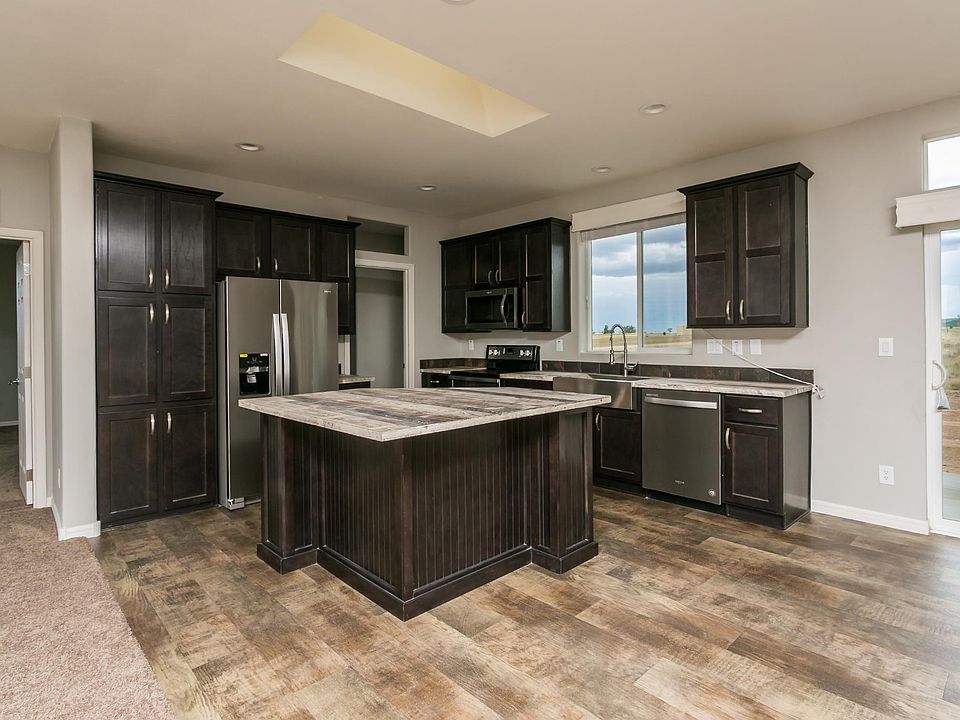 Kitchen - Solid wood cabinets, upgraded nickel hardware & full stainless appliance package, slate back-splash, corner island, country farmhouse sink w/ pull-out faucet.  Skylight & recessed lighting.