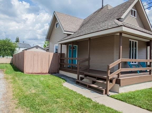 Front deck, fenced in yard and storage shed inside fence.