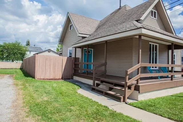 Front deck, fenced in yard and storage shed inside fence.