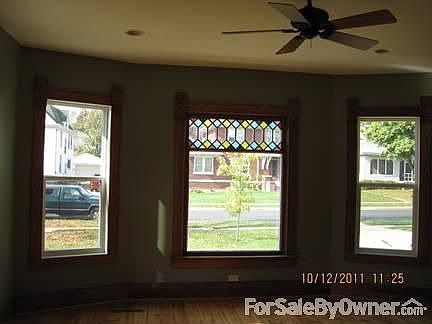 Living room
						:
						original wood floor, trim and stain glass window.