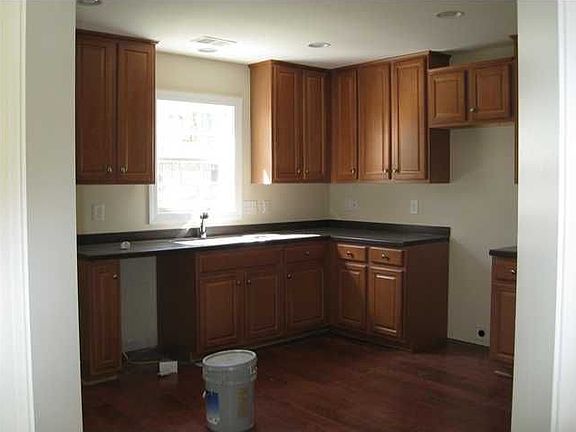 42 inch dark maple cabinets, sillstone countertops and cherry wood floors