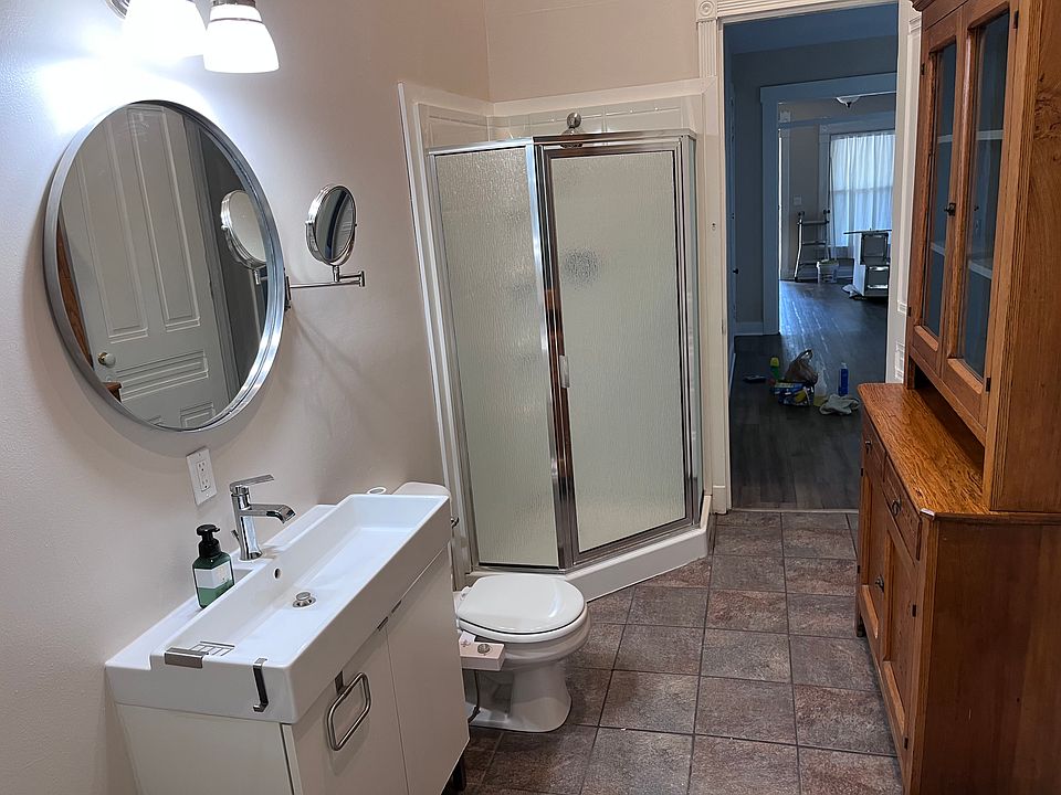 Bathroom with vaulted ceilings, plenty storage, stand alone shower, and bath tub.