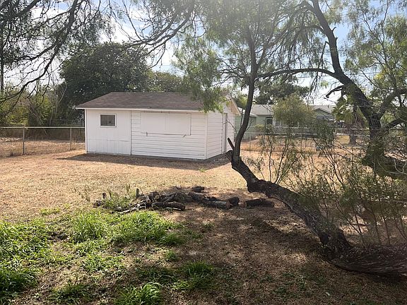 Large backyard with a tree