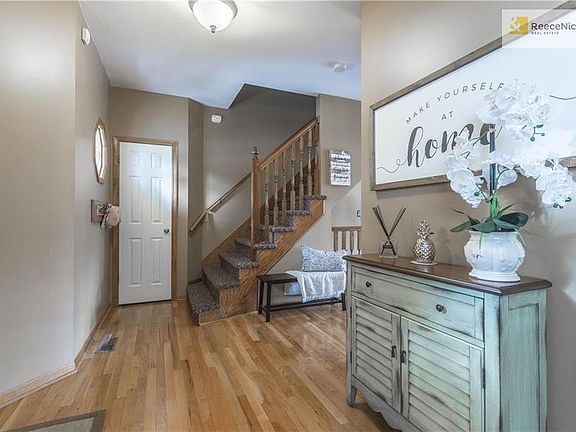 Hardwood floors in entryway and designer stair carpet