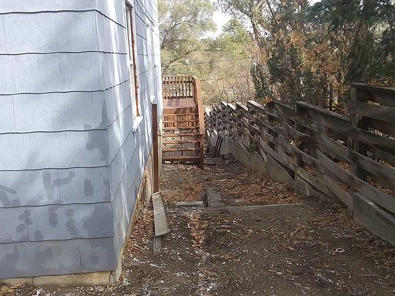 side yard leading up to the deck and fully fenced back yard