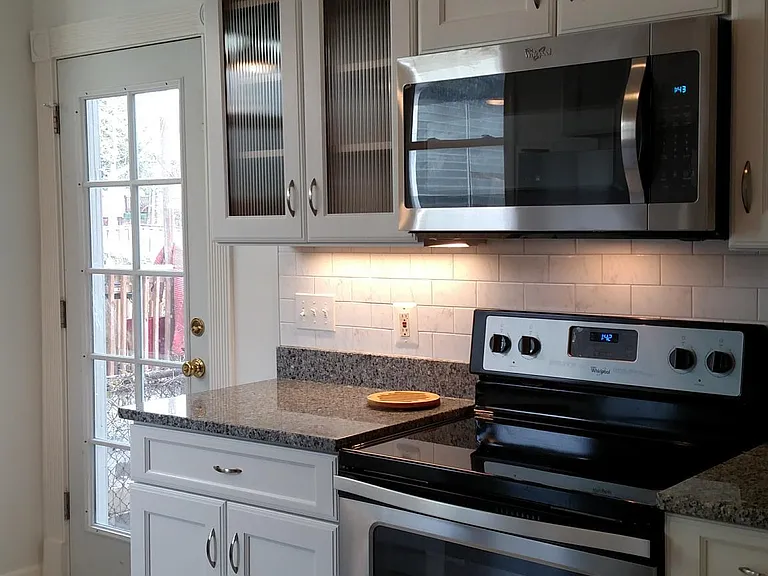 Recently renovated kitchen with stainless steel appliances, dishwasher, disposal, washer/dryer, and granite counter tops.
Exit to backyard.