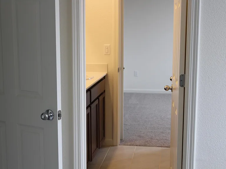 Photo is looking into bedroom. bathroom is between these 2 bedrooms.