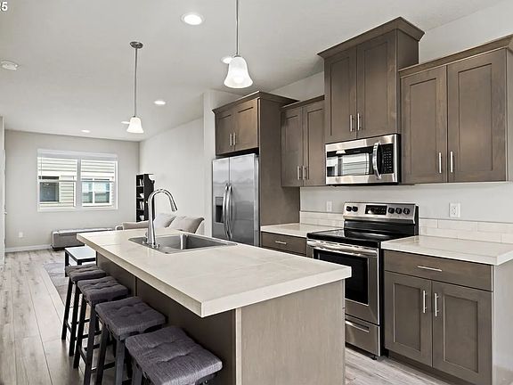 Kitchen and living room area with patio entrance.