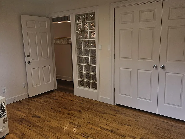 Bedroom 3 with original hardwood floors and huge closet.