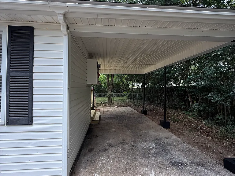 Single car carport with steps leading to new side deck