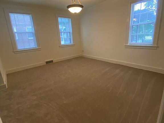 Formal dining room with 3 large windows