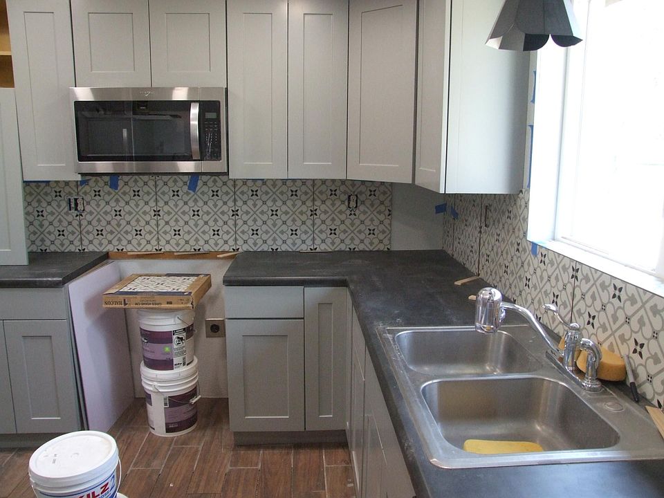 Kitchen in process: backsplash is nearly finished. Floor tile is not yet grouted.