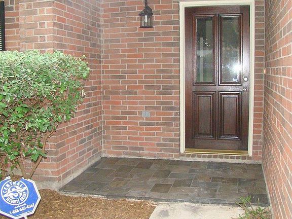 Guests will feel welcomed by this covered entrance with leaded glass wood door and slate porch floor