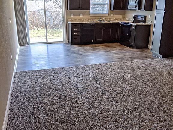 Spacious living room and kitchen with breakfast area and all new appliances.