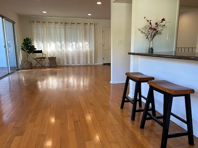 Facing open area towards front door.