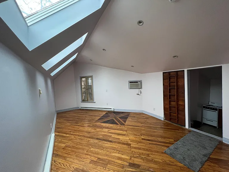 Bedroom/main room one of a kind hardwood floor and hand made solid wood doors. Cedar closet.