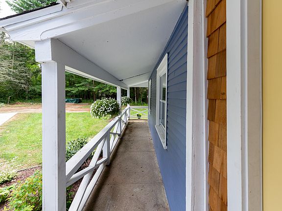 Front covered patio area wraps all the way around and leads