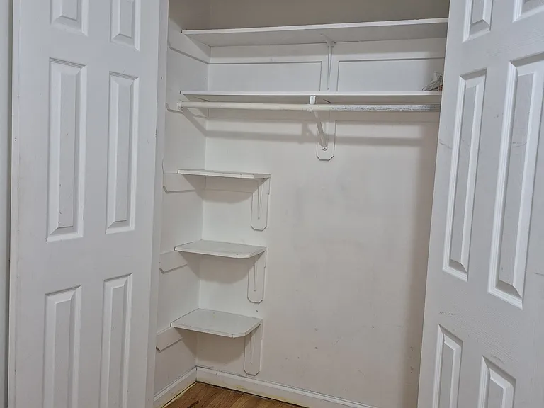 Spacious closet with built in shelving.