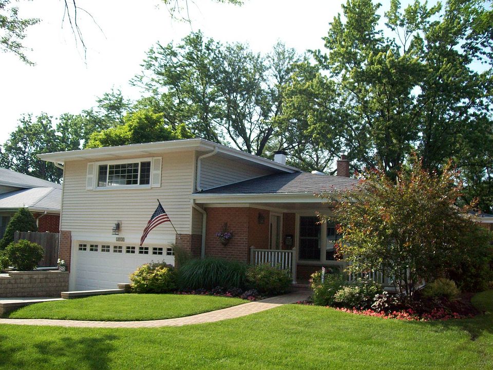 Front view with brick paver path and porch