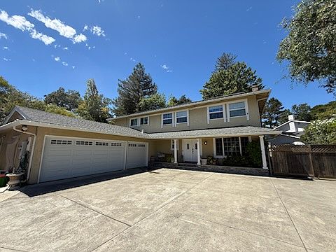 Front view with large driveway and parking
