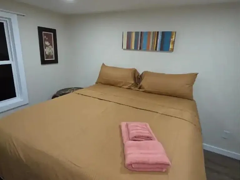 Comfortable bedroom with a full/queen bed, recessed lighting, and a window for ventilation and natural light.