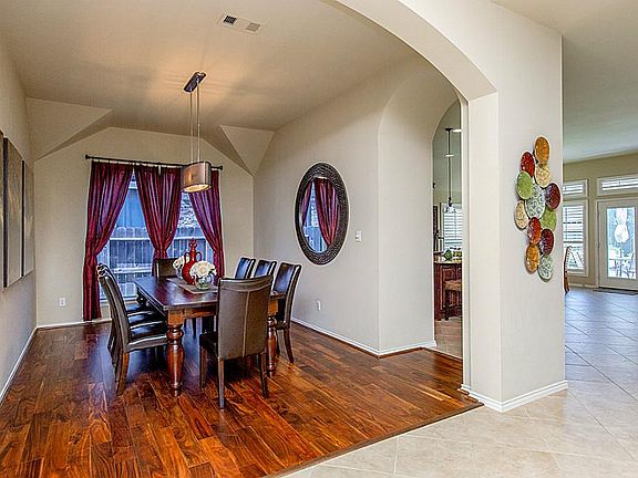 INVITING FORMAL DINING AREA FEATURING WOOD FLOORING ~