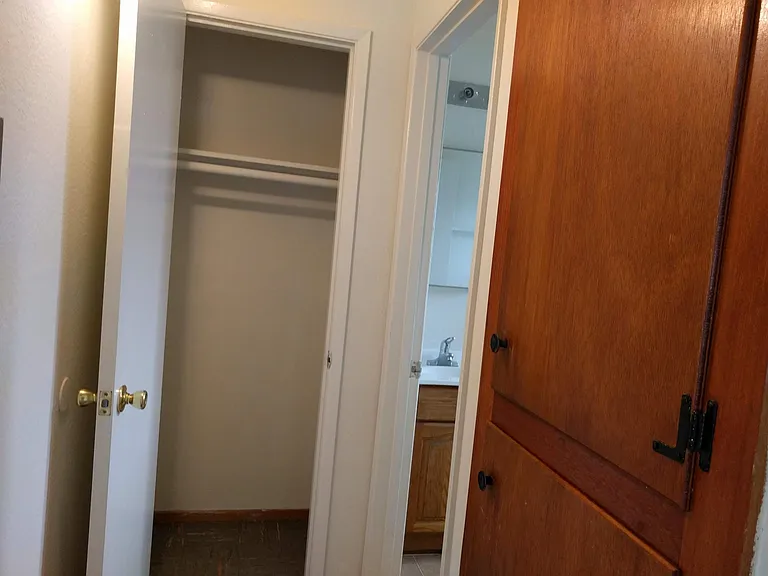 Hallway with multiple closets.