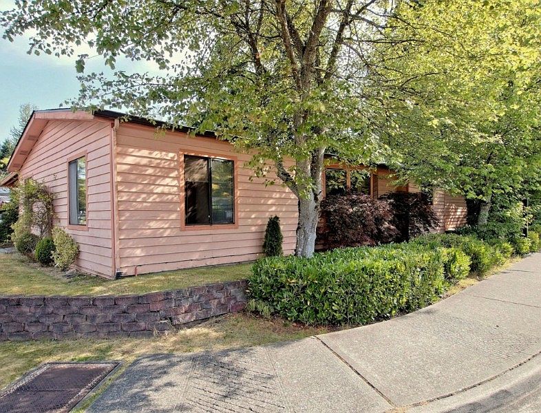 Great curb appeal with wrap around landscaping.