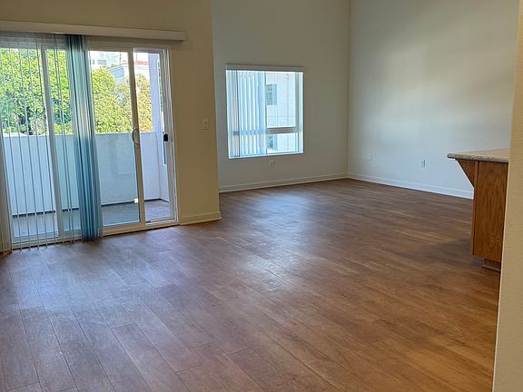 Dining & Living Room area with high ceilings and balcony pictured
