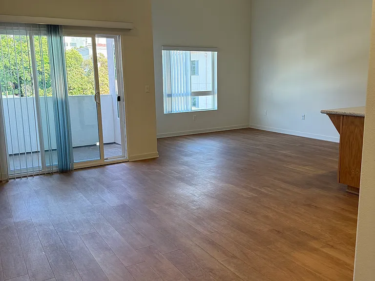Dining & Living Room area with high ceilings and balcony pictured
