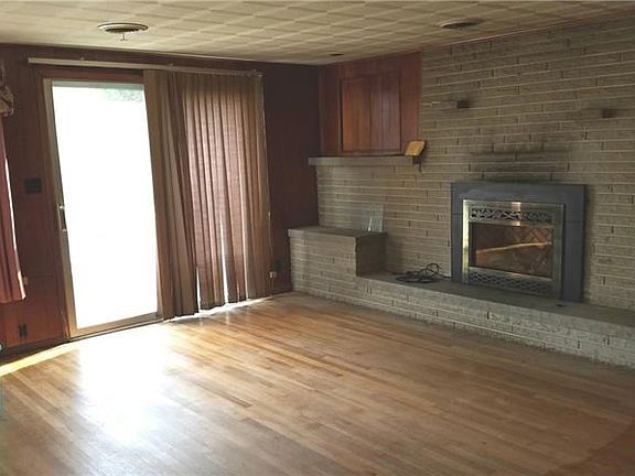 The family room-glass slider leads to concrete patio