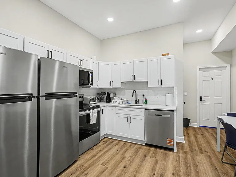 Kitchen with white shaker cabinets, subway-tile backsplash, and full stainless appliance package plus dishwasher.