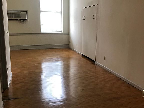 Murphy Bed that retracts adding additional living space to this studio apartment.