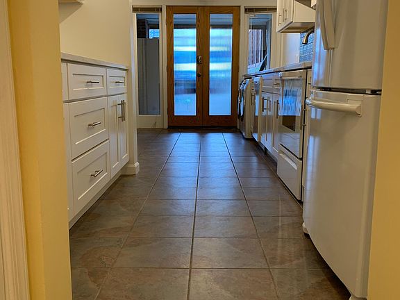 Long view of new kitchen and back French doors to alley