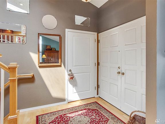 Enter to tall ceilings and interesting sight-lines to the living room and up to the open kitchen and family room.