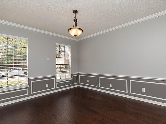 The formal dining room is located to the left of the entry. It features crown molding, chair rail and beautiful engineered hardwood floors.