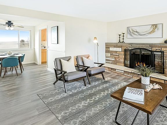 Stylish living room with mid-century fireplace, and new laminate plank floors. Dining room with Puget Sound views!
