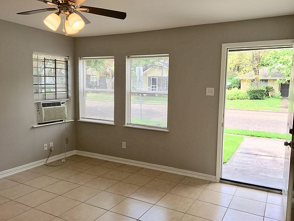 Bright natural light pours through the window into a spacious family room